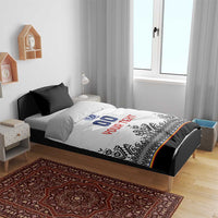 White duvet with blue crest, '00' and red 'YOUR TEXT', black Nordic trim, black pillows on bed