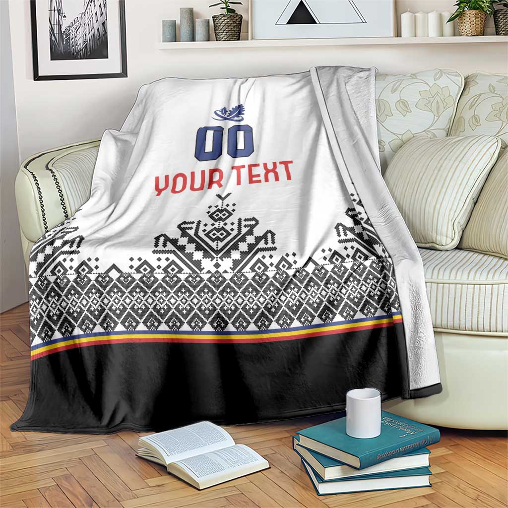 White blanket with blue crest and 00, red custom text, black patterned band and stripe