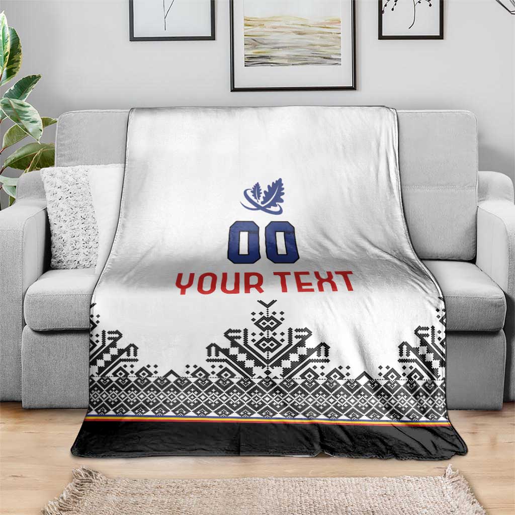 White blanket with blue crest and 00, red custom text, black geometric pattern and colored stripe