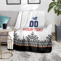 White blanket with blue crest and 00, red YOUR TEXT, black patterned lower band and stripe