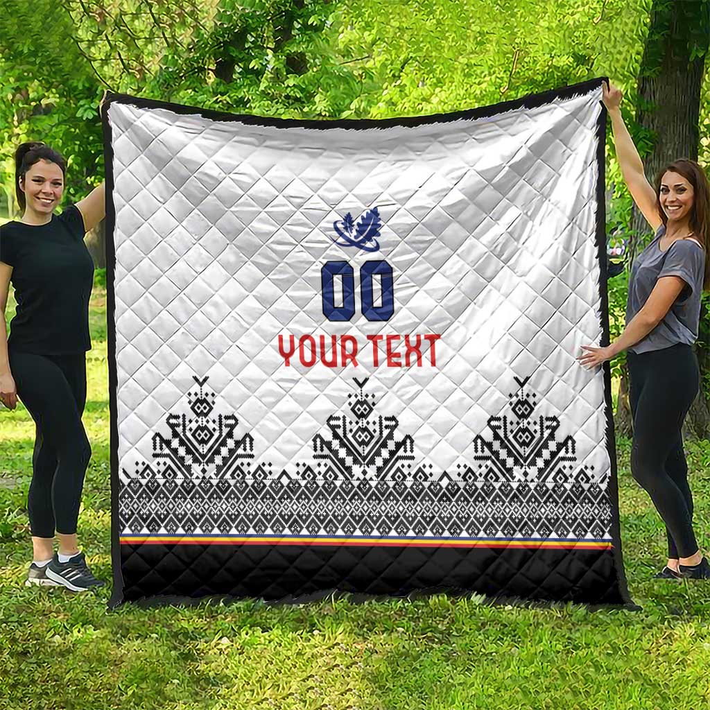 White quilt laid flat outdoors with blue 00 crest, red YOUR TEXT, black bottom trim