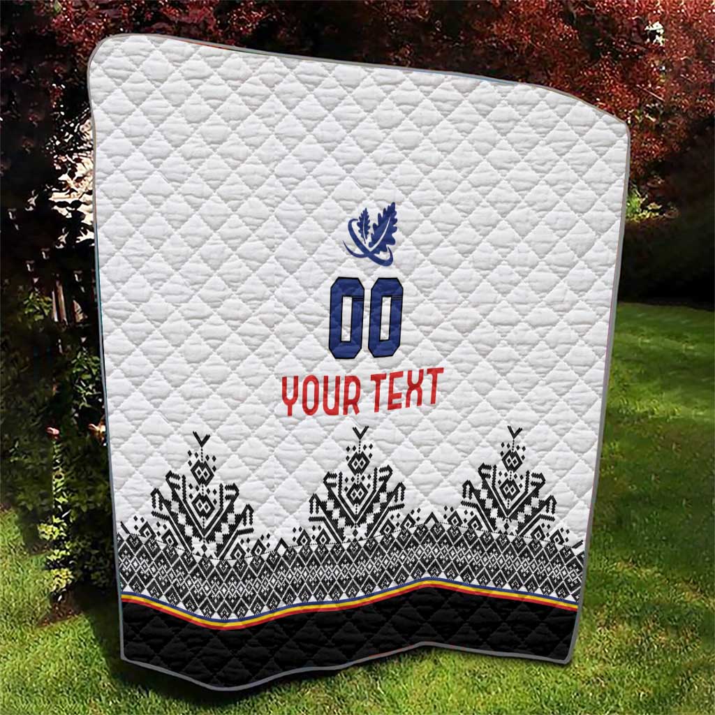 White quilt over grass with blue 00 crest, red YOUR TEXT, black-and-white geometric band