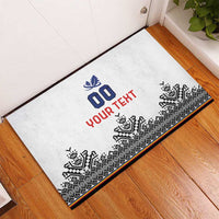 White rubber doormat laid on floor, showing 00 and bold custom red text