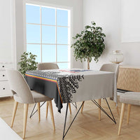 Custom rugby tablecloth on dining table, white top with black band and patterned stripe