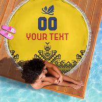 Yellow circular beach blanket with white fringe, 'YOUR TEXT' and blue leaf 00 symbol