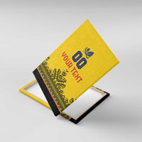 Yellow canvas wall art angled on black base, with rugby crest, 00, and custom text