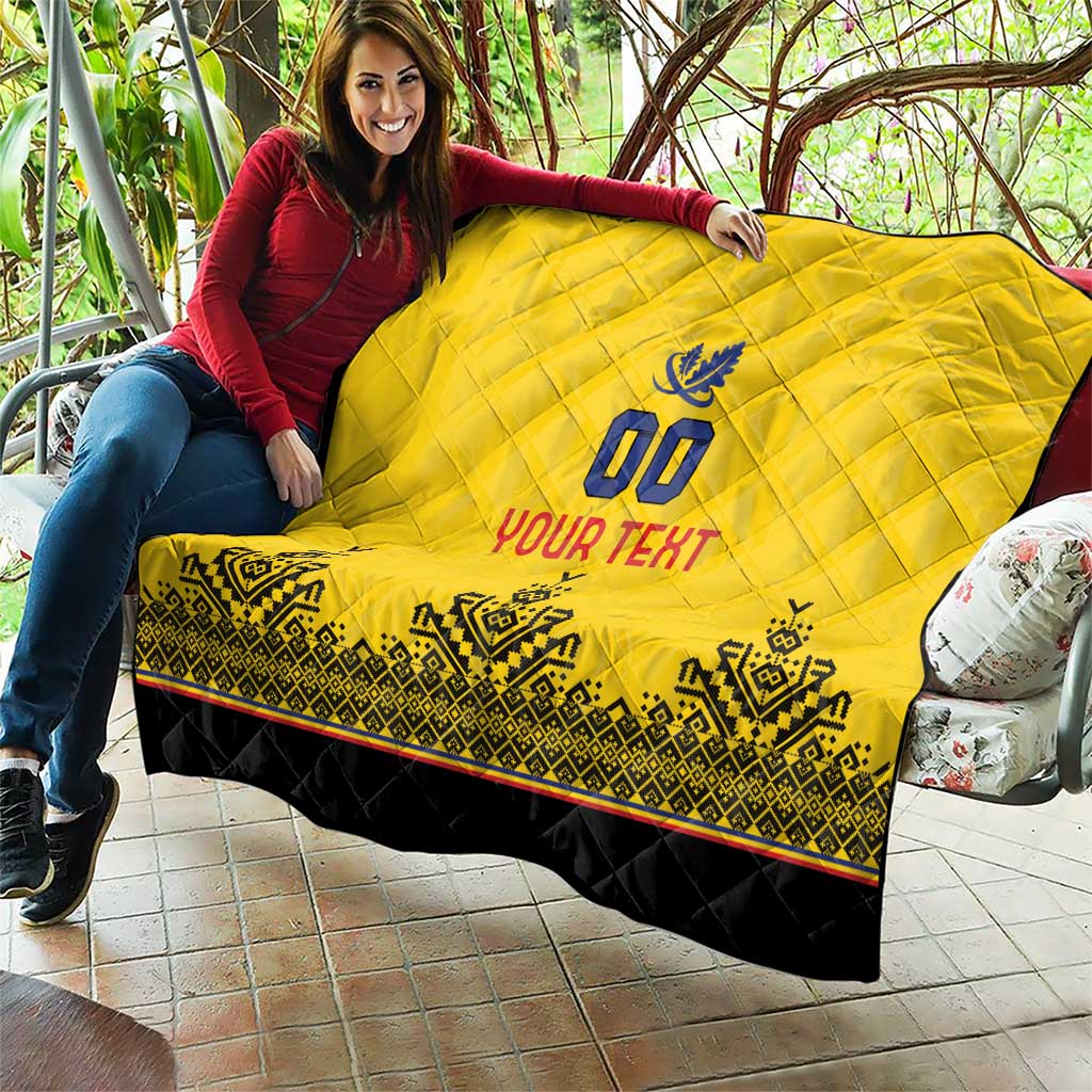 Yellow quilt blanket with diamond quilting, blue crest, "YOUR TEXT" text and black hem