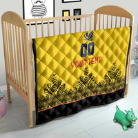 Yellow quilt draped on a wooden crib, diamond quilting, blue crest and "YOUR TEXT"
