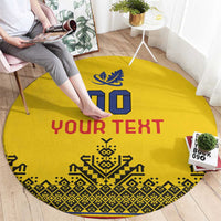 Round yellow custom rug with “YOUR TEXT”, blue crest, red text accents and patterned trim