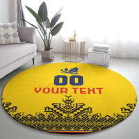 Round yellow rug with “YOUR TEXT”, blue crest design, red lettering and detailed patterned edge
