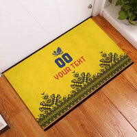 Yellow doormat with black edge trim, blue '00' and red 'YOUR TEXT'.