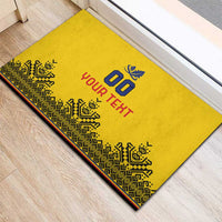 Yellow rubber doormat with geometric border, blue '00' and red 'YOUR TEXT'.