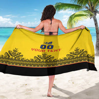 Yellow custom rugby sarong with black border and patterned bottom, held draped