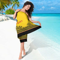 Yellow custom rugby sarong with black border and patterned hem, wrapped for a beach look