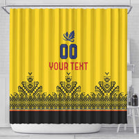 Yellow shower curtain with blue crest, 'YOUR TEXT' in red, black patterned border and hem