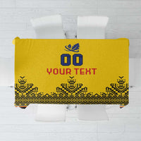 Yellow tablecloth design flat lay with blue crest, “Your Text,” and patterned trim.