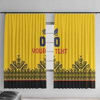 Yellow window curtains with bold blue and red central text and black geometric border