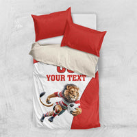 Red and white bedding set with lion mascot soccer ball graphic and “YOUR TEXT”, two red pillows