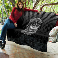 Black quilted throw with diamond pattern and grayscale alligator police graphic, draped