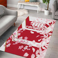 Red cherry blossom area rug with white petal pattern and centered decorative text