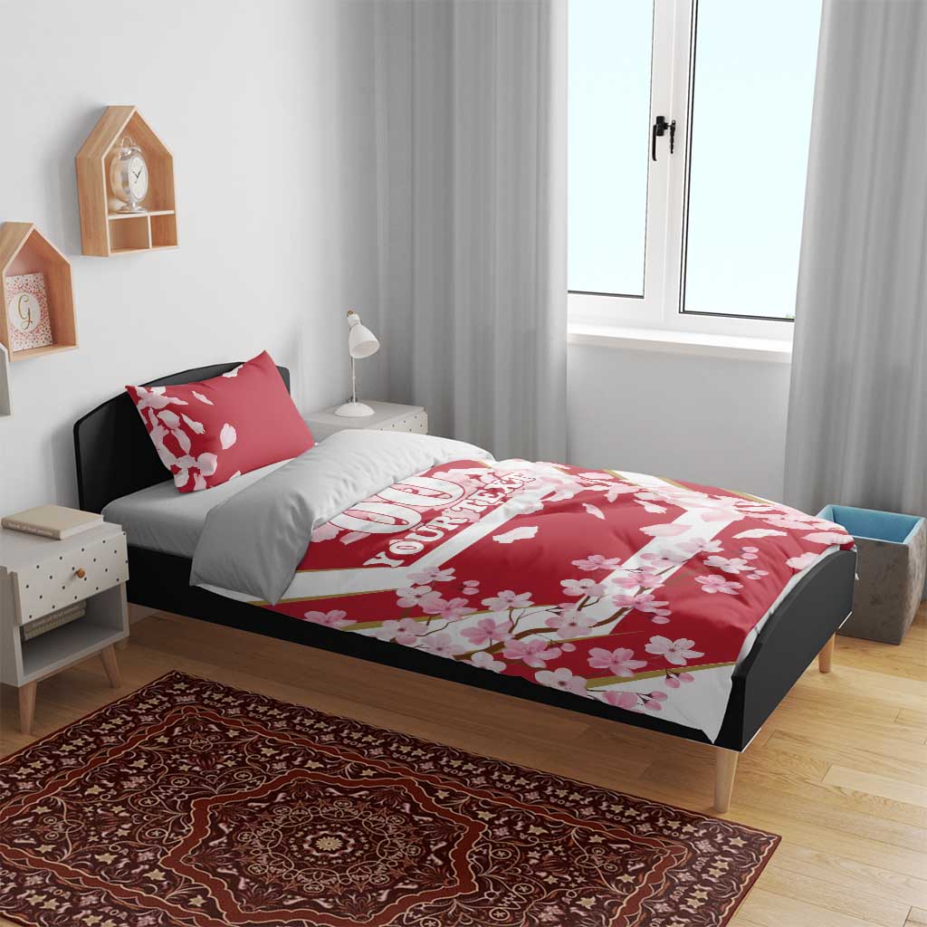 Red cherry blossom duvet cover and pillowcases on a bed, custom text strip
