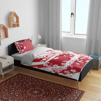 Red cherry blossom duvet cover and pillowcases on a bed, custom text strip
