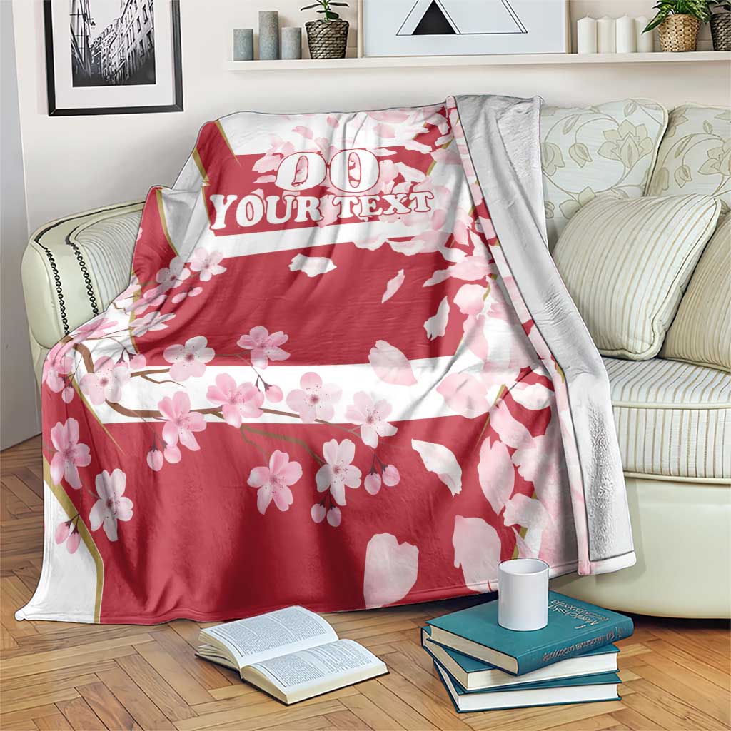 Red cherry blossom custom rugby blanket draped on sofa with '00 YOUR TEXT' design