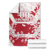 Custom rugby blanket, folded and displayed; red cherry blossoms with '00 YOUR TEXT' text