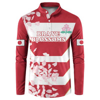 Red rugby button sweatshirt with white-and-pink cherry blossoms and 'BRAVE BLOSSOMS' graphic