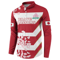 Red rugby button sweatshirt with 'BRAVE BLOSSOMS' logo, white stripe bands, cherry blossom print