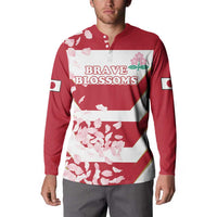 Red rugby button sweatshirt on model with front 'BRAVE BLOSSOMS' graphic and blossom print