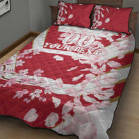 Red and white quilt bed set with cherry blossom pattern, two pillowcases