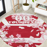 Red round carpet with pink cherry blossoms and custom text design
