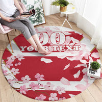 Red round carpet with pink cherry blossoms and bold custom text centerpiece