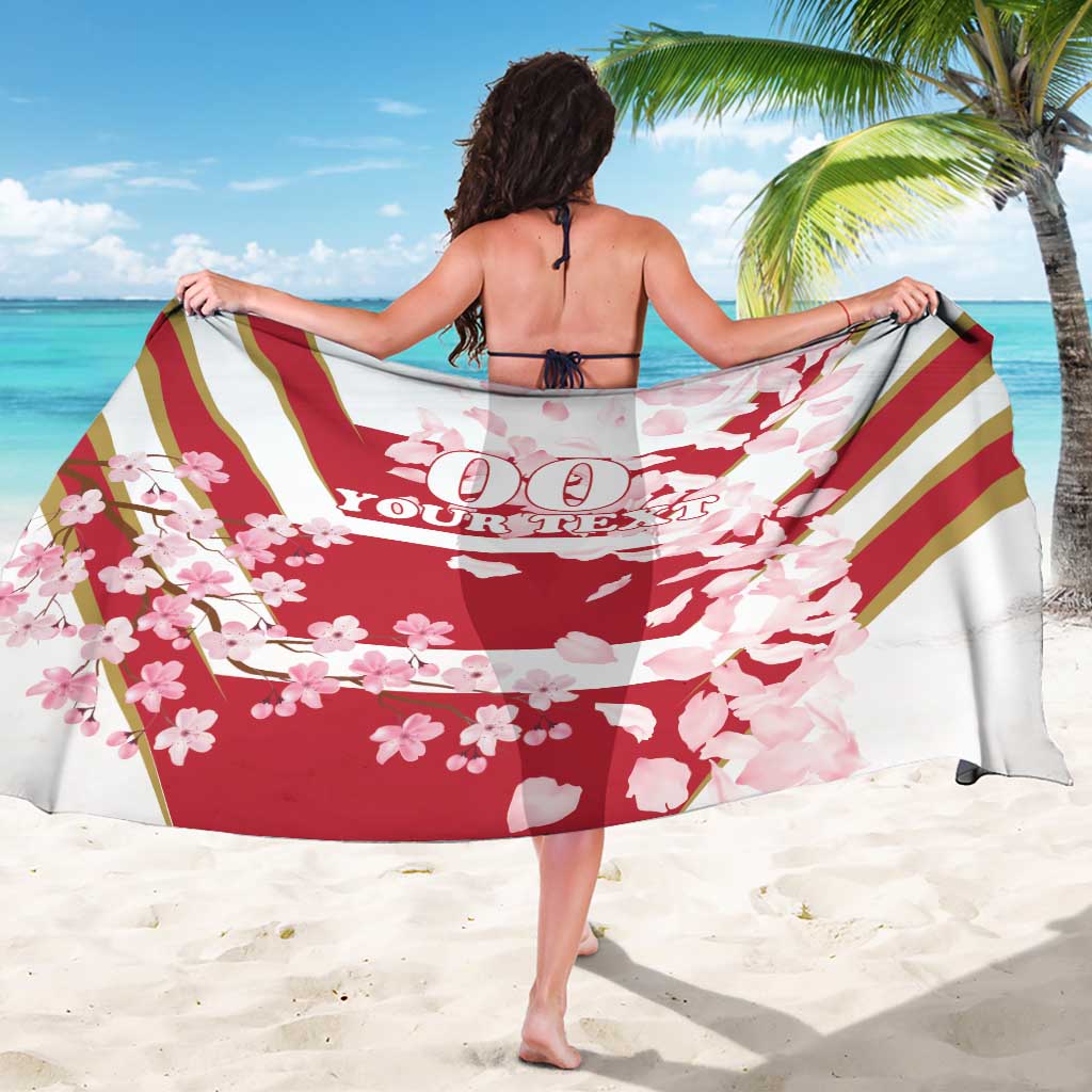 Red cherry blossom sarong with diagonal stripes and hanging custom text, beach wrap