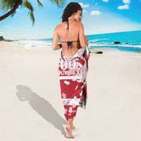 Red cherry blossom sarong wrap with diagonal stripe border and custom text, tied at waist
