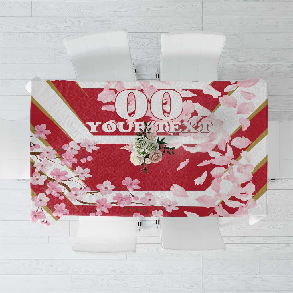 Red cherry blossom tablecloth with bold '100' and partial slogan text, on table