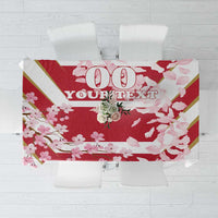 Red cherry blossom tablecloth with bold '100' and partial slogan text, on table