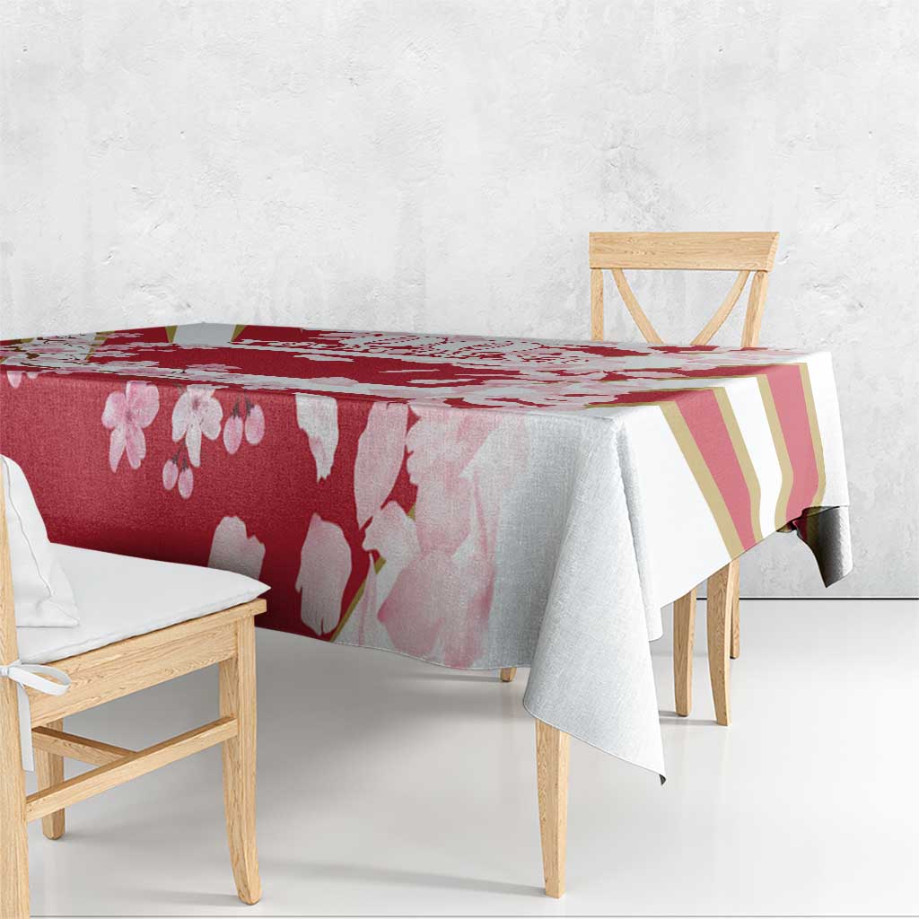 Red cherry blossom tablecloth with gold-striped section and pink petals, corner drape