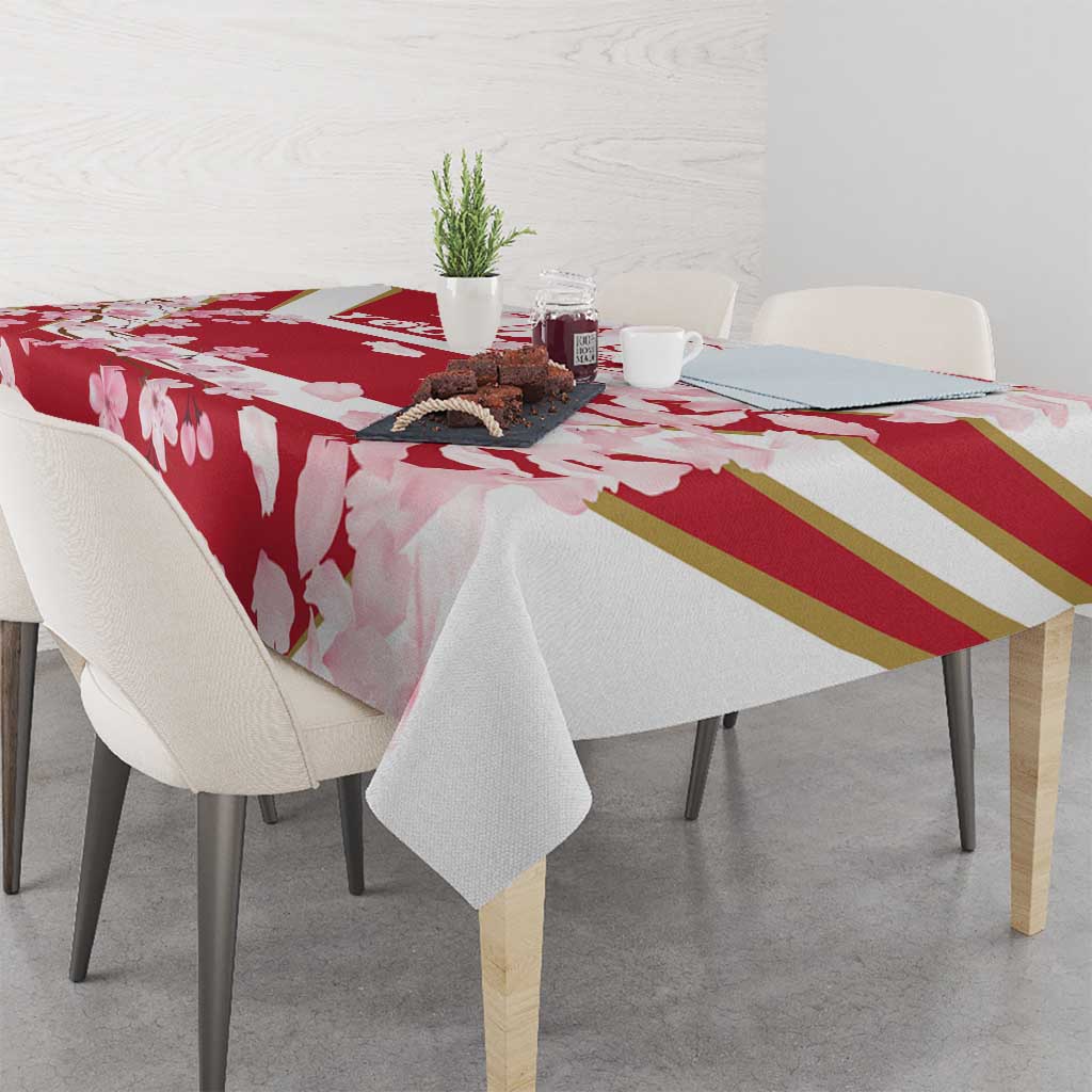Red cherry blossom tablecloth with gold stripe accents and pink flower pattern on table