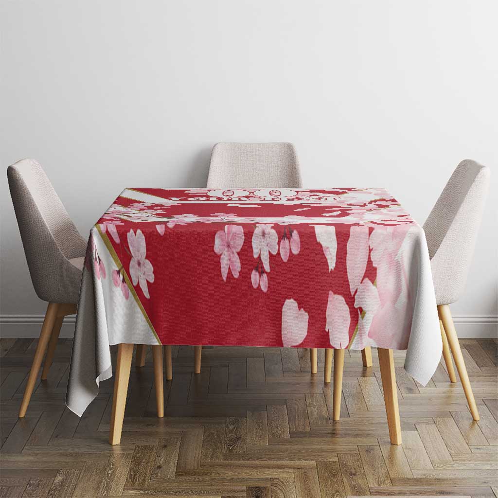 Red cherry blossom tablecloth with flying petals, draped over a square table