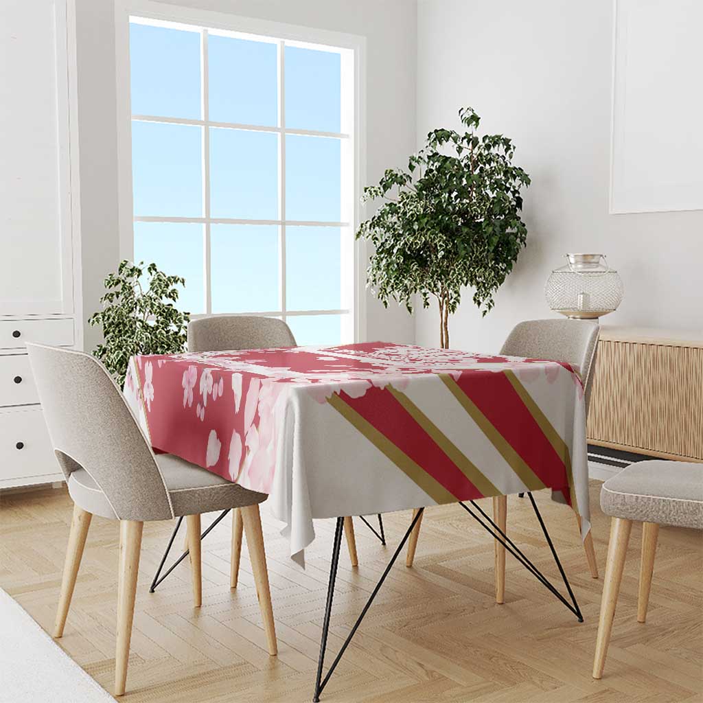Red cherry blossom tablecloth with petal print and gold stripe band on dining table
