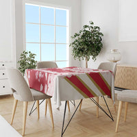 Red cherry blossom tablecloth with petal print and gold stripe band on dining table