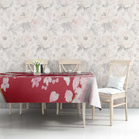 Red cherry blossom tablecloth with pale pink flowers, draped over dining table