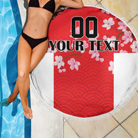 Red round beach blanket with fringe edge, wave ridges and cherry blossoms, custom text panel