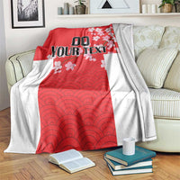 Red and white custom blanket with wave pattern and cherry blossoms, draped on sofa