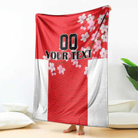 Red and white custom blanket with wave pattern and cherry blossom design, hanging