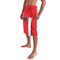 Red wave-pattern swim shorts with custom text panel and open side hem, 3/4 view
