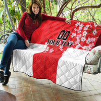 Red and white quilt draped on sofa, quilted texture, Japanese waves and cherry blossoms, custom text