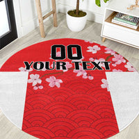 Red round rug with wave pattern, cherry blossom graphics, and custom text print.